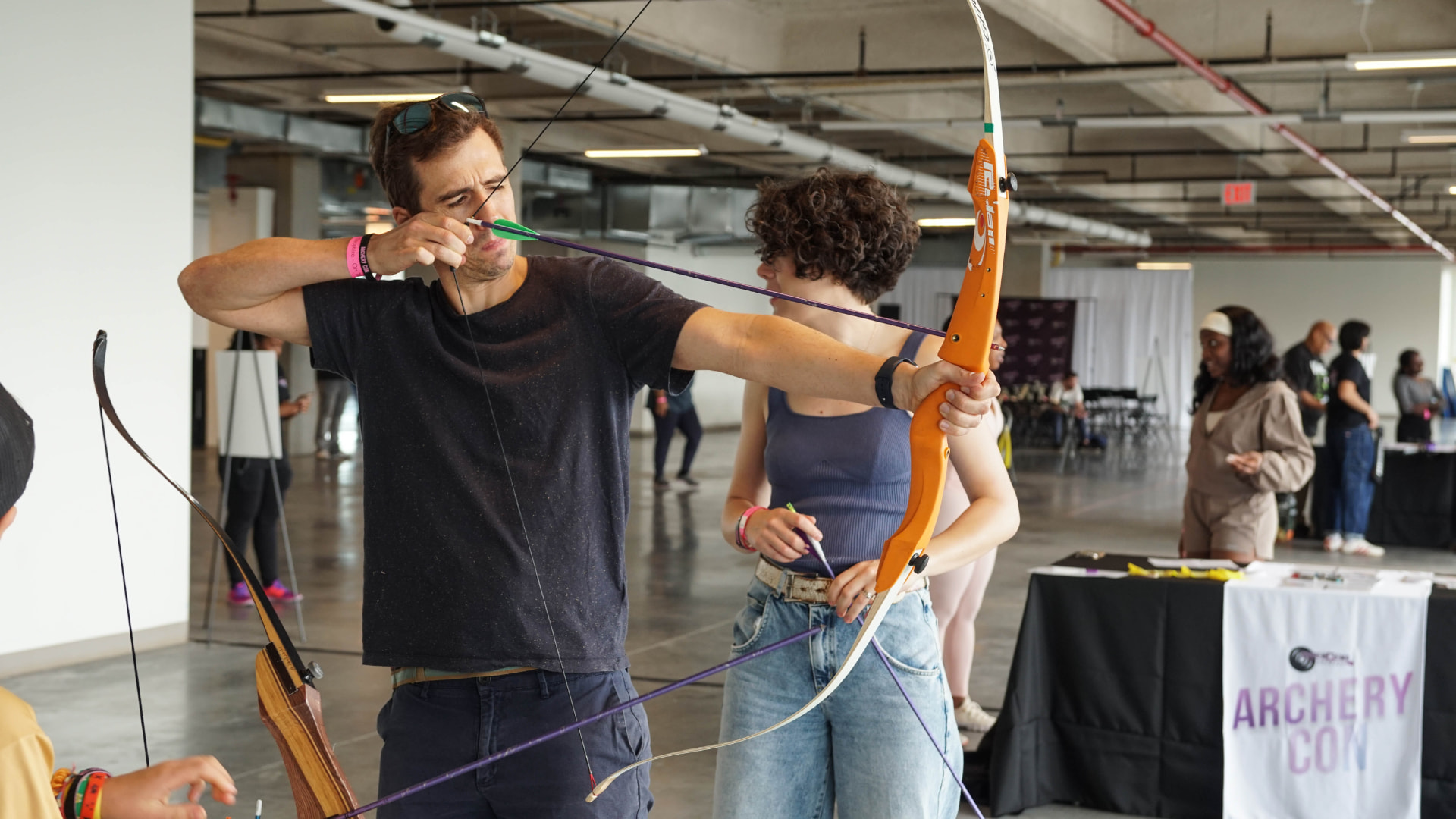 A first-time archer practicing their form at a coached session